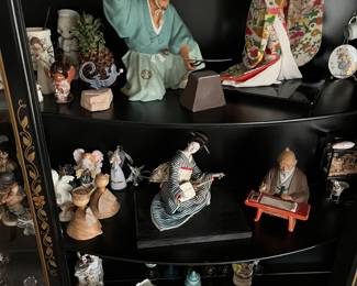 Vintage tea cups and saucers and Hawaiian figurines.