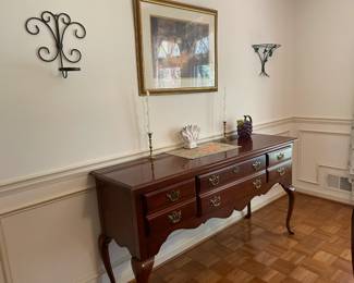 Cherry dining room set with six chairs, matching china cabinet and sideboard. Various wall decor, candlesticks