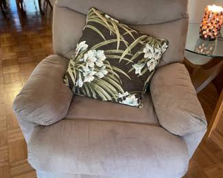 Beige/tan armchair with white and black floral pillow