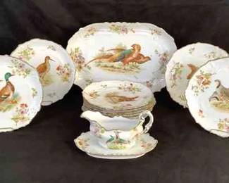GRLE211 Antique S CO Austria Bird Plates 10 salad/dinner plates, 1 serving platter, and a gravy dish. All hand painted with gold trim. Some of the gold trim is rubbing off. 1 plate looks like it may have a crack starting. All are porcelain as well.&nbsp;
