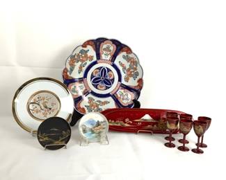 GRLE218 Vintage Japanese Decor A large size Japanese plate which does have some nicks and wear to it. 'The Art Of Chokin' 24k gold edge trim plate. 2 smaller size plates, one is hand painted, both made Japan. One red with Mountain View plate made of wood. 6 sake wood cups.
