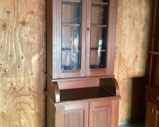 JIFI107 Tall Antique Maple Stained Cabinet  Rustic tall, one piece, with original flow glass in doors. Three adjustable shelves in upper half. Unfortunately no keys. Carved, detailed pattern on bottom doors. Very tall, slender piece.&nbsp;
