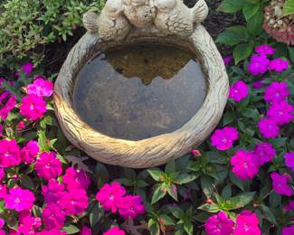 concrete bird bath, along with other outdoor yard decor