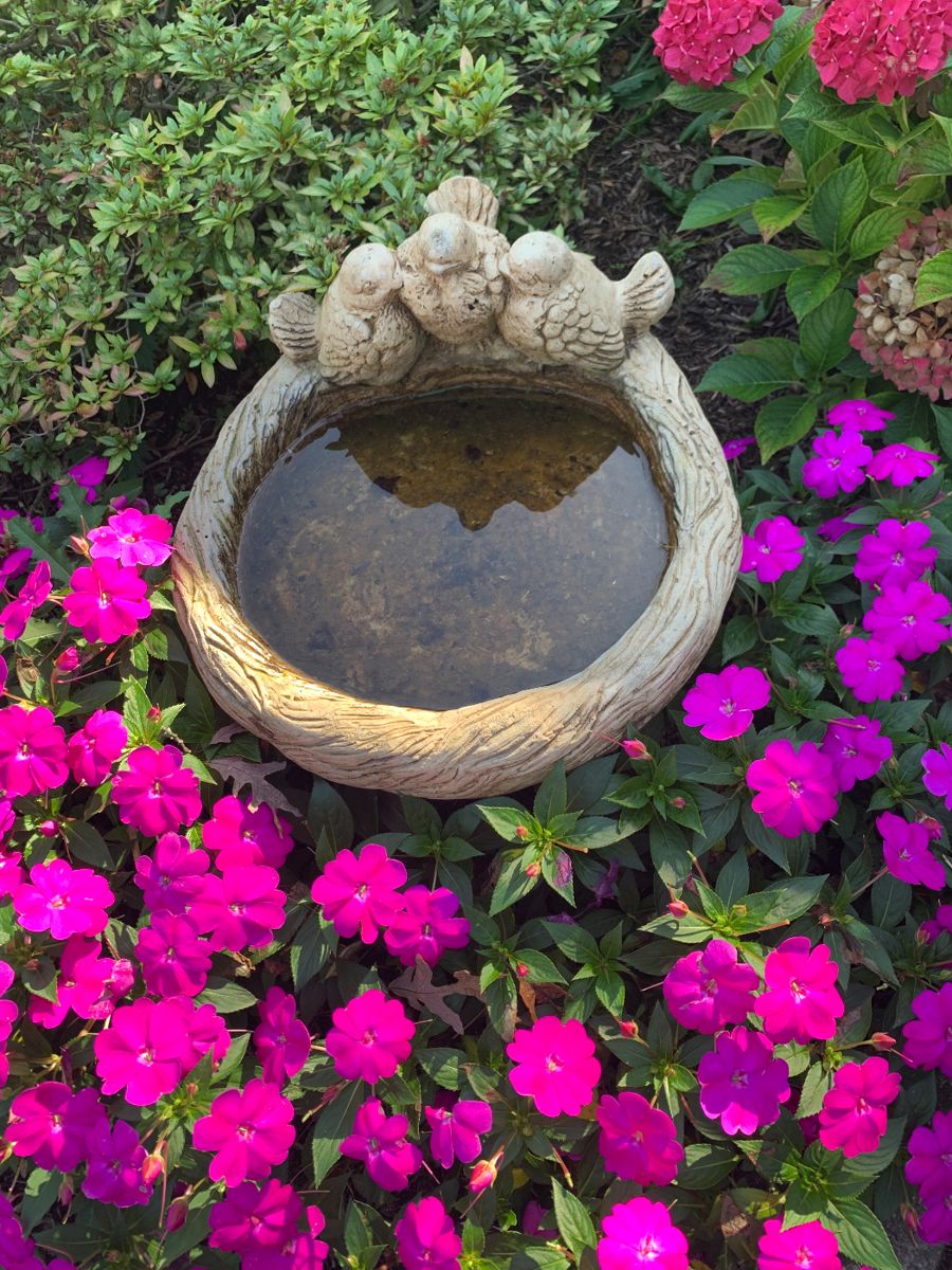 concrete bird bath, along with other outdoor yard decor