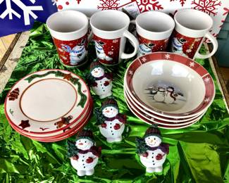 Christmas Themed Bowl and Mug set, 4 matching bowls, 4 matching mugs, 4 matching saucers; bowls, mugs and saucers are Christmas-themed but not matching set (see pics); includes 4 Snowman Napkin Rings (one is broken)