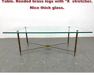 Lot 2190 Glass Top Brass Frame Cocktail Table. Reeded brass legs with X stretcher. Nice thick glass.