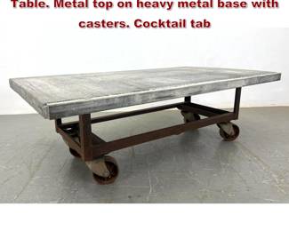 Lot 2253 Industrial Metal Rolling Cart Coffee Table. Metal top on heavy metal base with casters. Cocktail tab
