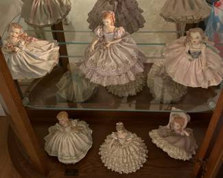 Dozens of vintage lace lady figurines.