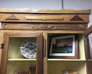 Corner Cabinet designed and handcrafted by Will Armstrong from Oak and Nebraska Walnut. Features an ocean scene with a sailing ship, flanked by center facing whales, Oak and Walnut carved fish above, topped by a hand carved cornice. Cabinet doors lock via a unique brass rod pull system.