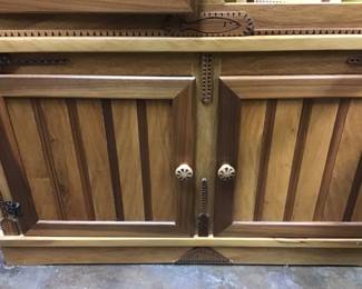 Corner Cabinet designed and handcrafted by Will Armstrong from Oak and Nebraska Walnut. Features an ocean scene with a sailing ship, flanked by center facing whales, Oak and Walnut carved fish above, topped by a hand carved cornice. Cabinet doors lock via a unique brass rod pull system.