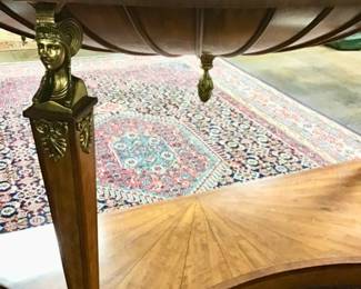 Large Maitland-Smith empire style, inlaid console supported by brass female figures. Inlaid starburst tops the desk. Brass Laurel leaf ormolu accents. Carved acanthus leaf frieze along the top edge.