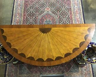 Large Maitland-Smith empire style, inlaid console supported by brass female figures. Inlaid starburst tops the desk. Brass Laurel leaf ormolu accents. Carved acanthus leaf frieze along the top edge.