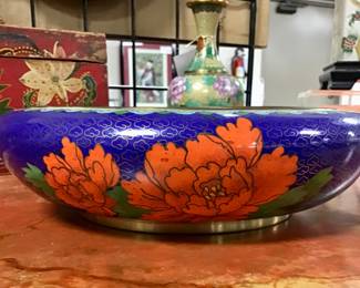 Large round Chinese cloisonné squat bowl on blue background. Gilded copper bronze base and rim. Brilliantly colored peonies and birds cover the entire bowl. A true work of art.