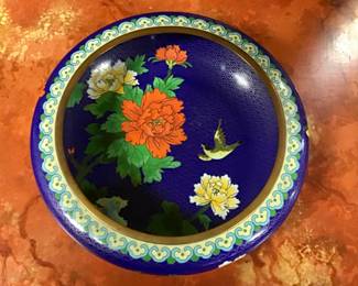 Large round Chinese cloisonné squat bowl on blue background. Gilded copper bronze base and rim. Brilliantly colored peonies and birds cover the entire bowl. A true work of art.