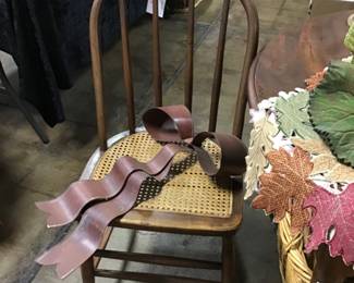 Vintage cane seat chair with spindle back. Circa 1930s.