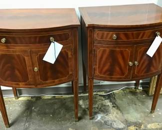 Elegant bow front cabinet featuring exotic flame mahogany veneer and satinwood string inlay. Maitland Smith.