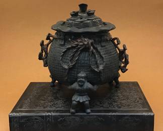 Mid-1800s iron incense burner. Moneybag Supported by three men. 