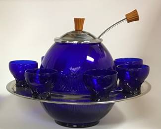 Art Deco cobalt blue “Saturn” punch bowl set. 7 cups on chrome ring around the bowl. Chrome lid and handle both topped with Bakelite knobs.