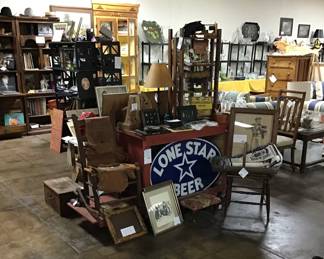 Red outdoor bar/potting bench with open back and lower side shelf.  24 x 30 oval  Lonestar medal sign. 1920s cowhide ladder back rocking chair.  Cayman/alligator under side pelt Matte 59 x 24.  Cast iron covered wagon doorstop. Arrowheads, lots of nice western collectibles