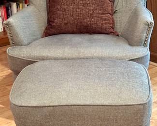 Gray upholstered Chair and Ottoman.