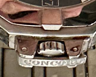 Rare Stainless Steel Men's Concord Saratoga (Model 14.C2.1894 with Black Face and Date Complication. Very collectible Swiss-Made Quartz Movement. Stainless Steel Band with deployment buckle.