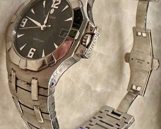 Rare Stainless Steel Men's Concord Saratoga (Model 14.C2.1894 with Black Face and Date Complication. Very collectible Swiss-Made Quartz Movement. Stainless Steel Band with deployment buckle.