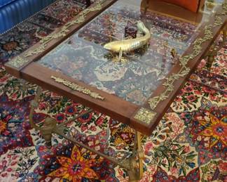 Wood and brass trimmed glass top coffee table