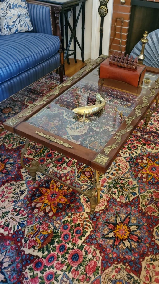 Wood and brass trimmed glass top coffee table