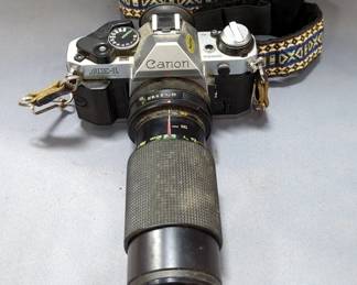Canon AE-1 Program Camera With Strap, Albinar Thyristor 90 MDT-Z Camera Flash, Canon Power Winder A In Leather Case, Vivitar 52mm Camera Lens, And Kodak Camera Carrying Case