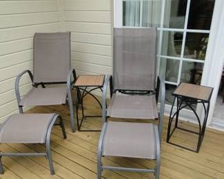 Relax in these patio chairs, with matching foot rests, and side tables