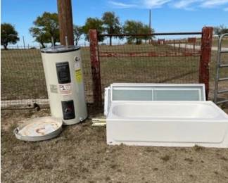 60-gallon water heater, pans, NEW bath tub, 2 shower door sets
