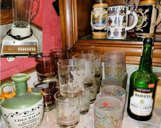 Bar items.  Retro blender, Neiman Marcus glass sets, German beer steins and ceramic decanters