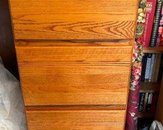 Wood file cabinet full of photo frames