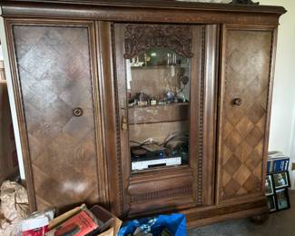 Three door wood display cabinet. This comes apart in sections.