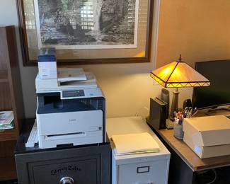 Liberty Safe, desk, Slag glass lamp pair, and cool print of dude diving off of waterfall.