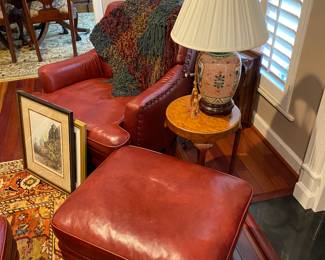 Pair of red leather chairs with ottomans.