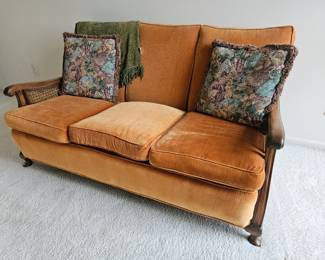 Orange sofa, with 2 matching chairs in basement