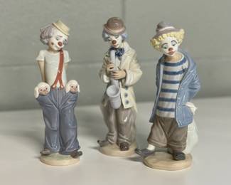 Trio of Lladro Clowns: Little Pals Clown with Puppies #7600, Sad Sax Clown #5471 & Little Traveler Clown #7602. 