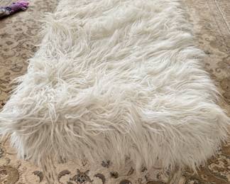 Faux fur bench with lucite legs