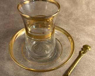 Gold rimmed glass, saucer and spoon