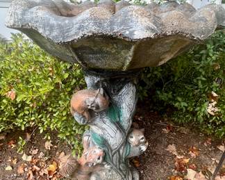 Cement squirrel bird bath
