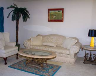 Upholstered couch and chair, glass top coffee table