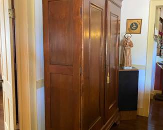 This is one of many absolutely gorgeous armoires. This one is a walnut Louisiana piece. Clean French Empire lines with that simple arched bracket base. We have rosewood, cypress, and other wonderful pieces.