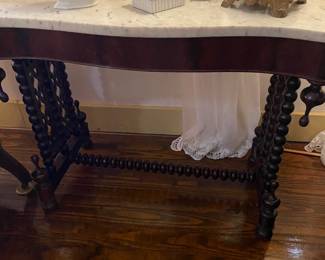 One of my favorite tables. I love the carved spindle legs and the pristine white marble top.