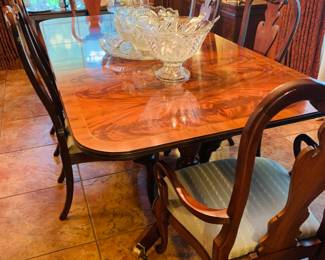 Gorgeous Flame Mahogany dining table by Hekman which comes with 8 chairs and table that has one more leaf than pictured