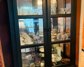 Large lighted china cabinet filled with crystal and china