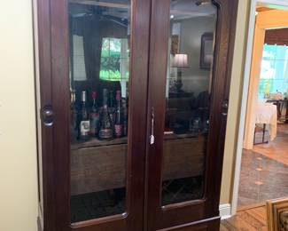 Beautiful glass front cabinet that makes into a bar