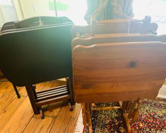 Two different sets of wooden TV trays