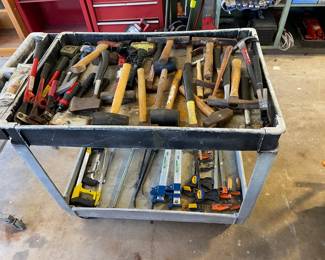 Push cart full of various hammers / bar clamps