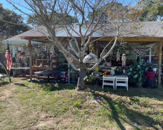 Front yard has a ton of whimsical items, chimes, decor an d more